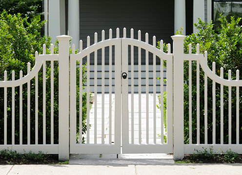 White Wooden Gate And Picket Fence On Elegant Home Entrance