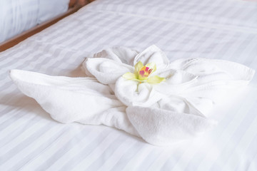 Fototapeta na wymiar White towel on bed decoration in bedroom