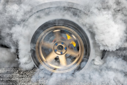 Drag racing car burns tires in preparation for the race