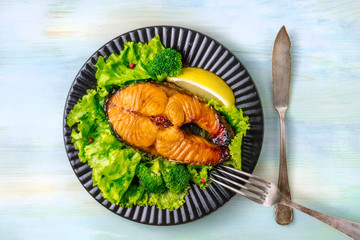 Grilled salmon steak with green lettuce and broccoli