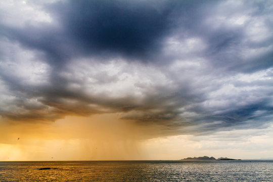 Calm sea under cloudy sky