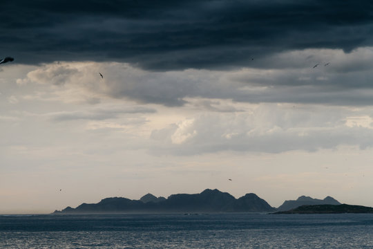 Calm sea under cloudy sky