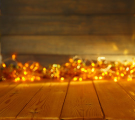 Wooden background with bright lights with a free space for text or product demonstration