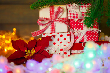 Christmas card. Background on a theme of New Year's  party. Decorated fir-tree with gifts and candles on the background of colorful festive lights. A magical evening.