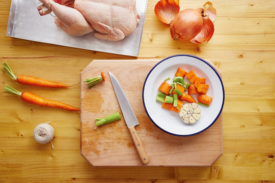Preparing roast chicken with vegetables