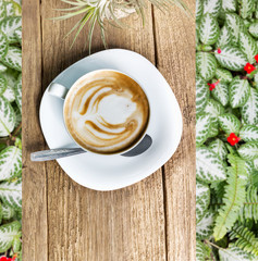 Cup of hot coffee on wooden table top view