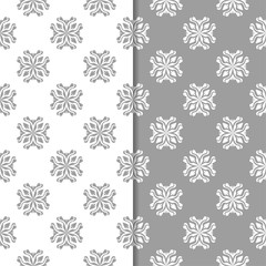 White and gray floral backgrounds. Set of seamless patterns