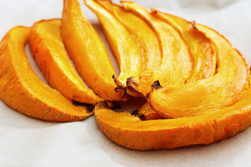 Pieces of sweet baked pumpkin closeup. Selective focus.