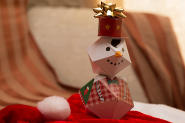 macro paper snowman on red carpet