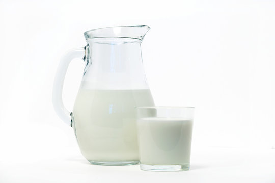glass jug with milk and glass on white background