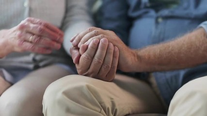 senior couple holding hands