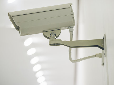 Security camera on the wall in the modern building