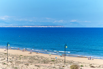 Obraz na płótnie Canvas People on the beach of La Mata. Torrevieja, Spain