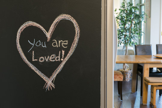 You Are Loved Written On Kitchen Chalkboard