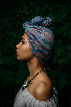 Profile of stylish woman wearing turban
