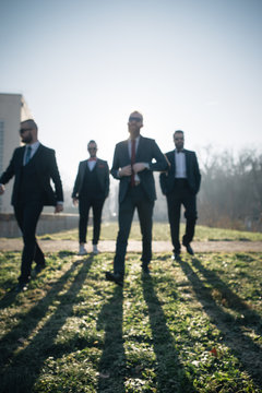 A group of four urban gentlemen in suits