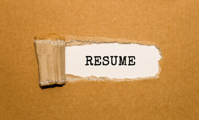 The text RESUME appearing behind torn brown paper