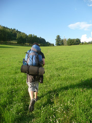 Man hiking in mountains with big bag