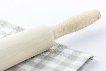 Wood Rolling Pin on White and Beige Chequered Cotton Kitchen Towel. Tabletop. Baking Essentials. Holidays Christmas Easter. Clean Minimalist Style. Copy Space