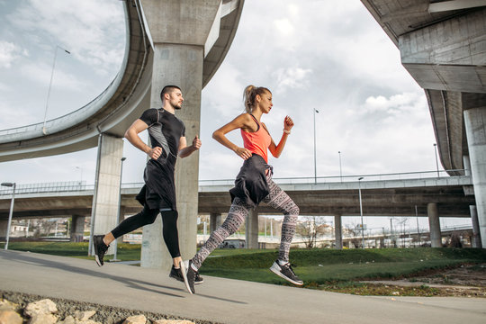 Couple Running Together Outside.