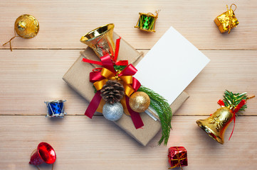 Christmas gift box,paper note and new year decoration on wood plate.Flat lay.Christmas and New year concept.