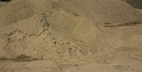 heaps of sand on a brown stand