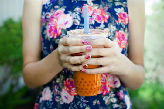 Teen girl drinking a refreshing bubble tea or boba drink