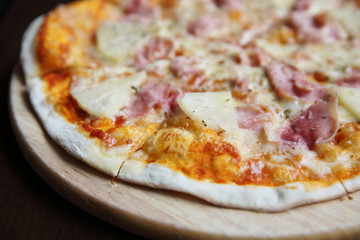 pizza hawaiian , pizza with pineapple and ham with cheese and tomatoes sauce on wood background , italian food
