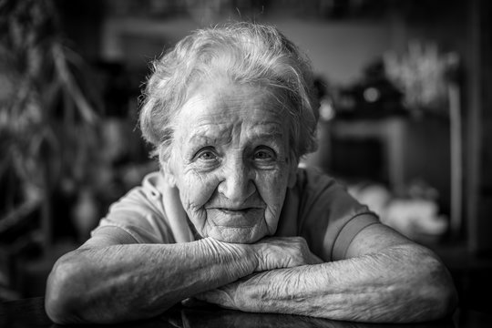 Black-and-white closeup portrait of an elderly woman.