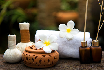 Obraz na płótnie Canvas Thai Spa massage compress balls, herbal ball and treatment spa, relax and healthy care with flower, Thailand. Healthy Concept.