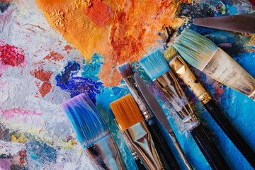 Artistic brushes on painted canvas