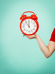 Woman holding old red big clock watch
