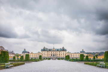 View over Drottningholm Palace and park on a cloudy autumn day. Home residence of Swedish royal family. Famous landmark and tourist destination in Stockholm, Sweden