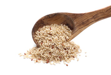 Integral, brown rice and wooden spoon isolated on white background