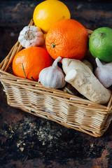Citrus fruits with ginger roots inside basket.