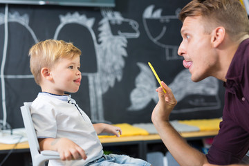 Cute little boy at speech therapist session. Private one on one homeschooling.