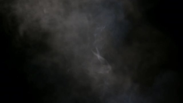 Smoky fog clouds over a black background. You can add this footage to your video project by dropping it in and changing its blending mode to Screen or Add. Perfect for Halloween videos and trailers.