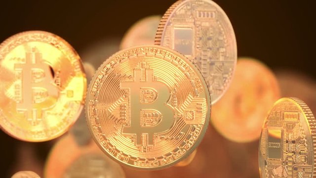 3D Rendering  value added concept show a lot of golden bitcoin Spinning around and moving up from below very slow on a dark orange Background and rendering with shallow depth of field.