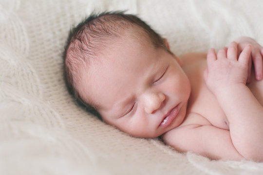 Headshot portrait of a sleeping newborn baby