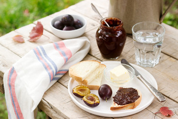 Toasts with plum chocolate jam. Breakfast in the garden. Rustic style, selective focus.