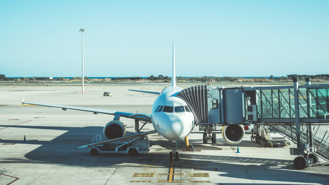 Plane at the airport wih boarding ramp