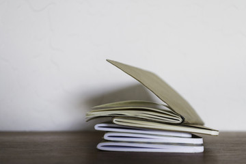 stack of notebooks on a desk