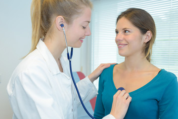 Doctor listening to patient's chest with stethoscope
