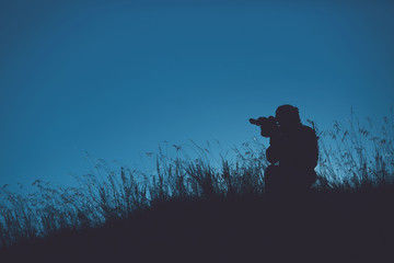 military soldier with weapons at sunset. shot, holding gun, colorful sky. military concept.