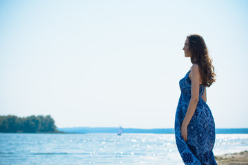 A middle-aged woman rests on a city waterfront on a day off. The concept of femininity and romance...