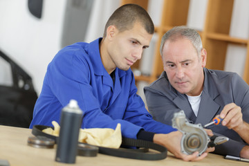 manager with apprentice holding bearing