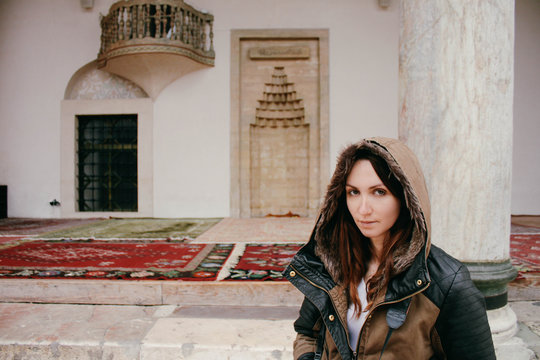 Portrait of a female model near mosque