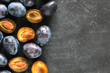 Plums on black board.
