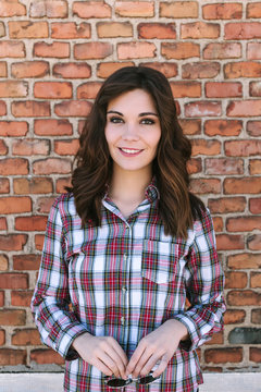 Young Casual Woman over Against a Brick Wall