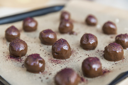 Chocolate candy with raspberry powder drying